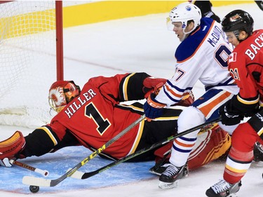 The Edmonton Oilers' Conner McDavid, scores on Calgary Flames goaltender Jonas Hiller during the third period of NHL action at the Scotiabank Saddledome Saturday October 17, 2015.