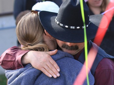 Supporters hug at the Withrow Gospel Mission prior to a balloon release in memory of the three Bott sisters; Catie, 13, Dara, 11, and Jana, 11,  who died in a tragic farm accident earlier this week.