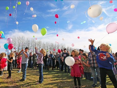 Several hundred people turned out at the Withrow Gospel Mission for prayer music and a balloon release in memory of the three Bott sisters; Catie, 13, Dara, 11, and Jana, 11,  who died in a tragic farm accident earlier this week.