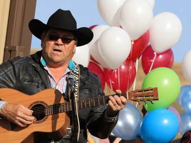 Musicians sing at the Withrow Gospel Mission prior to a balloon release in memory of the three Bott sisters; Catie, 13, Dara, 11, and Jana, 11,  who died in a tragic farm accident earlier in the week.