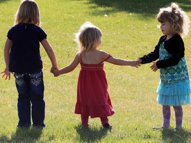 Three girls play at the Withrow Gospel Mission prior to a balloon release in memory of the three Bott sisters; Catie, 13, Dara, 11, and Jana, 11,  who died in a tragic farm accident earlier this week.