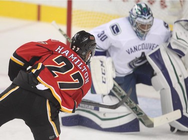 Calgary Flames new arrival Dougie Hamilton misses in close on Vancouver Canucks goalie Ryan Miller in the first period of the season opener Wednesday October 7, 2015 at the Saddledome.