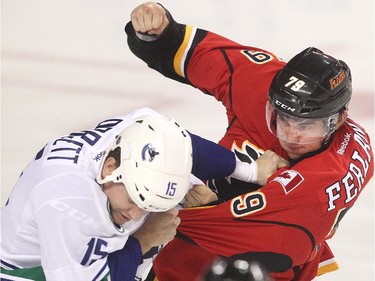 The season opens with a bang as Micheal Ferland of the Calgary Flames squares off with Derek Dorsett of the Vancouver Canucks in the opening seconds of the first period of the season opener Wednesday October 7, 2015 at the Saddledome.
