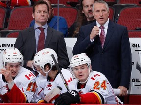 Head coach Bob Hartley, right, and assistant coach Martin Gelinas of the Calgary Flames have a tight timeline on plays they want to challenge this season.