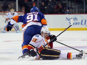 Flames forward Johnny Gaudreau, seen being dumped by New York Islanders star John Tavares during Monday's game, leads the team in scoring with 10 points in nine games, but his line has accounted for half of Calgary's point production so far. More secondary scoring is sorely needed for the Flames to get out of their slump.