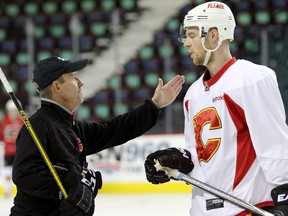 Calgary Flames assistant coach Jacques Cloutier, left, with Flames player Matt Stajan during Flames practice at the Scotiabank Saddledome in Calgary on October 9, 2015.