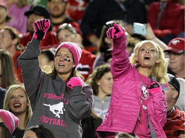 Fans sing during the Calgary Stampeders and Edmonton Eskimos Pink Power game at McMahon Stadium in Calgary on October 10, 2015.