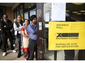 Calgarians line up outside a polling station in the northeast during advance voting.