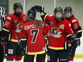 Calgary Inferno players Brianne Jenner, left, Brittany Esposito, Jacquie Pierri and Erica Kromm celebrate a goal during their 7-1 win over Boston on Saturday night. The Inferno swept the series with a 4-1 win on Sunday morning.