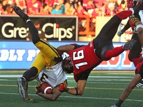 Calgary Stampeders Marquay McDaniel takes down the Hamilton Tiger-Cats Johnny Sears Jr. during their season opener.