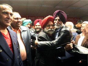 Liberal candidate Darshan Kang for Calgary's Skyview constituency gets a hug from a supporter at his campaign office.
