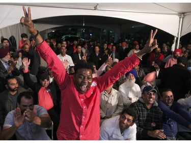 Liberal candidate Darshan Kang's campaign office erupted with cheering as Liberals took the lead nationally in Calgary on Oct. 19, 2015.