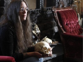 Lynne Ellis-Smith, blogger and owner of Insomniac's Attic, poses with some of her ghoulish items at her home in the foothills .
