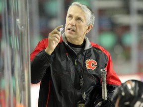 Calgary Flames head coach Bob Hartley gives instructions to his team at practice.