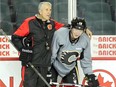 Calgary Flames head coach Bob Hartley gives Ladislav Smid some instructions during a recent practice. Sidelined since last January, Smid has a good chance of playing his first NHL game in nine months when the Detroit Red Wings visit on Friday.