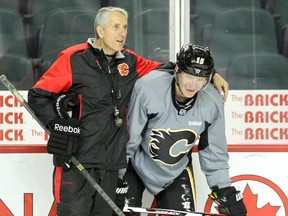 Calgary Flames head coach Bob Hartley gave Ladislav Smid some instructions to the team during practice at the Scotiabank Saddledome on Oct. 12, 2015.
