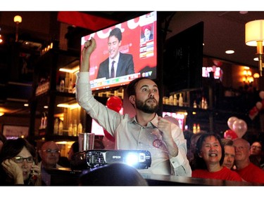 Liberal supporter Aleksandar Samardzija raised his arm as Kent Hehr pulled ahead in the vote count.