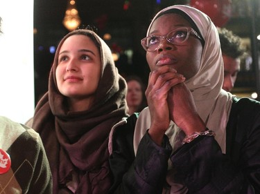 Liberal supporters Ala Buzreba, left, and Aishat Gbadamosi waited and watched as the results rolled in at the Calgary Centre headquarters of Liberal Candidate Kent Hehr as a media outlet declared a Liberal majority government i on October 19, 2015.