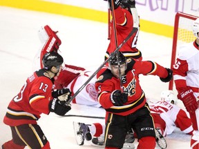 Calgary Flames defenceman Mark Giordano, right, celebrated with teammate Johnny Gaudreau after the Captain scored the game winning goal against the Detroit Red Wings in overtime during NHL action at the Scotiabank Saddledome on October 23, 2015. The Flames broke their home losing streak with the 3-2 overtime win over Detroit.