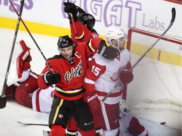 Calgary Flames defenceman Mark Giordano, left celebrated with teammate Sean Monahan, background, after the Captain scored the game winning goal against the Detroit Red Wings in overtime during NHL action at the Scotiabank Saddledome on October 23, 2015. The Flames broke their home losing streak with the 3-2 overtime win over Detroit.