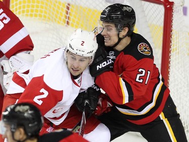 Calgary Flames left winger Mason Raymond and Detroit Red Wings defenceman Brendan Smith got tied up with each other during second period NHL action at the Scotiabank Saddledome on October 23, 2015. The Flames were looking to break their home game losing streak.