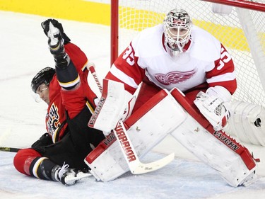 Calgary Flames centre Jiri Hudler went flying into the goal post of Detroit Red Wings goalie Jimmy Howard during second period NHL action at the Scotiabank Saddledome on October 23, 2015. The Flames were looking to break their home game losing streak.