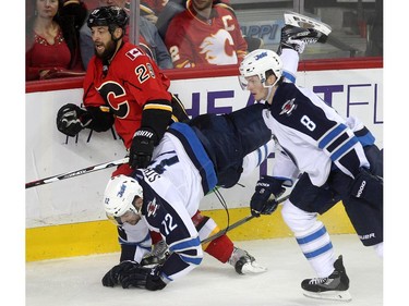 Calgary Flames defenceman Deryk Engelland sent Winnipeg Jets right winger Drew Stafford crashing to the ice  during second period NHL action at the Scotiabank Saddledome on October 3, 2015.