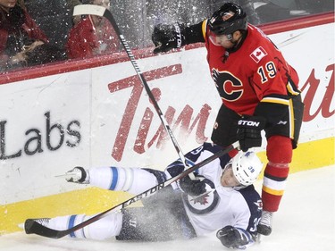 Calgary Flames right winger David Jones followed Winnipeg Jets defenceman Toby Enstrom into the boards during third period NHL action at the Scotiabank Saddledome on October 3, 2015. The Jets defeated the Flames 3-2.