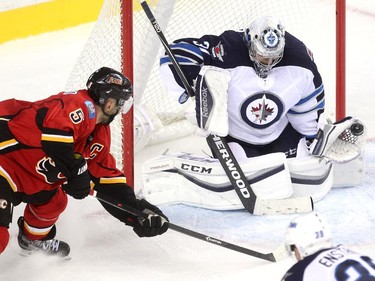 Calgary Flames defenceman Mark Giordano unleashed a shot on Winnipeg Jets goalie Ondrej Pavelec during first period NHL action at the Scotiabank Saddledome on October 3, 2015.