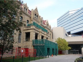 The old Calgary City Hall has been surrounded by scaffolding and green hoarding after a chunk of the building fell off. It was photographed on September 22, 2014.