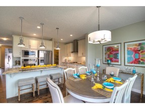 The dining area and kitchen in the Avonley II by NuVista Homes.