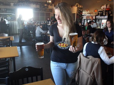 Ellie Forte is all smiles as she serves up draught at Wild Rose Brewery's Currie Barracks taproom Wednesday October 28, 2015.