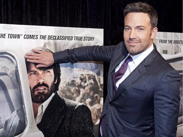 Director and actor Ben Affleck covers his '70's hairstyle on a movie poster while posing for photographers at the premiere of his film Argo in Washington, Wednesday, Oct. 10, 2012. A screening and reception for the Hollywood film "Argo" at the Canadian embassy in Washington last fall was such a hot ticket, people complained afterwards about not getting invited.