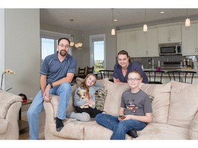 Seann and Shauna Eldan with son Logan and daughter Alyssa at their new home in Legacy.
