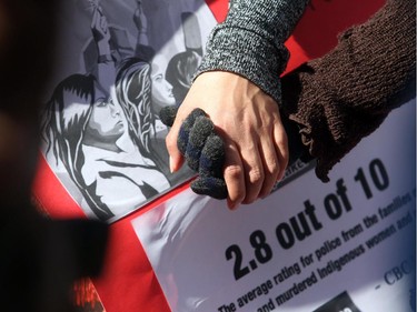 Mourners hold hands during a prayer circle at the Sisters In Spirit ceremony for missing and murdered aboriginal women Monday October 5, 2015 at City Hall. Dozens walked from City Hall to Eau Claire in the 11th annual march and ceremony.