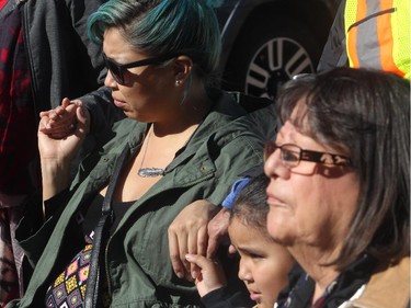 Chantelle Many Chief, left, and her son Zane hold hands during a prayer circle at the Sisters In Spirit ceremony for missing and murdered aboriginal women earlier this month at Calgary City Hall.