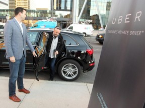 Uber driver Paul Lee held the door as Calgary businessman and philanthropist W. Brett Wilson climbed out of the back of Lee's Uber vehicle after catching a ride downtown as  rider zero during the morning rush hour on October 15, 2015. Uber officially hit the streets of Calgary Thursday afternoon.