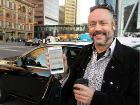 Calgary businessman and philanthropist Brett Wilson showed off the Uber app after catching a ride downtown as the company's first Calgary customer.