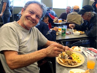 Michele Dupis was very happy with his dinner at the Drop in Centre on October 12, 2015. It was the Alfred Balm Day of Thanksgiving Holiday with a turkey dinner sponsored by Alfred Balm. earlier socks were handed out and a roast beef lunch was also served.