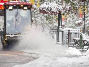 Snow crews work hard to remove the snow and slush on Stephen Avenue on September 10, 2014.