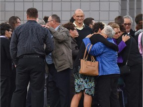 Family embrace after a public memorial for Terry Blanchette, 27, and his two-year-old daughter, Hailey Dunbar-Blanchette, took place on Friday, Oct. 9 in Coleman, at Crowsnest Consolidated High School.