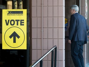 Conservative Leader Stephen Harper arrives at a polling station to cast his ballot in the federal election in Calgary on Monday, Oct. 19, 2015.