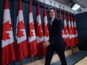 Prime Minister-designate Justin Trudeau smiles as he leaves his first news conference since winning the election, at the National Press Theatre, in Ottawa, Tuesday, Oct.20, 2015.