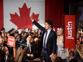 Liberal Leader Justin Trudeau and wife Sophie Gregoire wave to the crowd after his speech at Liberal election headquarters in Montreal, Que. on Monday, Oct. 20, 2015.