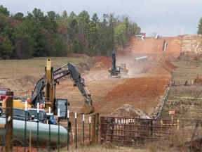 In this Dec. 3, 2012 file photo, crews work on construction of the TransCanada Keystone XL Pipeline near Winona, Texas.