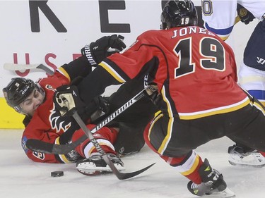 Calgary Flames Mark Giordano fights for the puck during game action against the St. Louis Blues at the Saddledome in Calgary, on October 13, 2015.