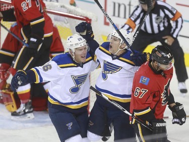 St. Louis Blues Scottie Upshall, right, celebrates his goal with Paul Stastny during game action against the Calgary Flames at the Saddledome in Calgary, on October 13, 2015.