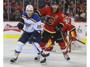 Calgary Flames captain Mark Giordano battles St. Louis Blues Paul Stastny during game action at the Saddledome in Calgary, on October 13, 2015.