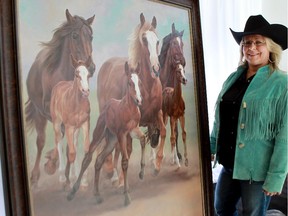 Artist Michelle Grant poses with her work titled Born to Buck, the 2016 Stampede promotional poster.
