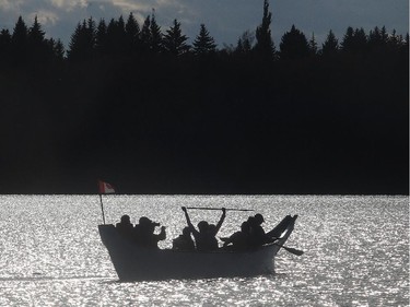 A 40 foot Spirit Dancer canoe on a sunset paddle around Glenmore Reservoir at sunset Wednesday October 7, 2015. The paddlers are local canoe and outdoor enthusiasts and member of the Bow Waters Canoe Club. The canoe was built by Clipper in Abbotsford, BC with funds raised by Calgarians and is destined for the Canadian Canoe Museum in Peterborough, Ontario.